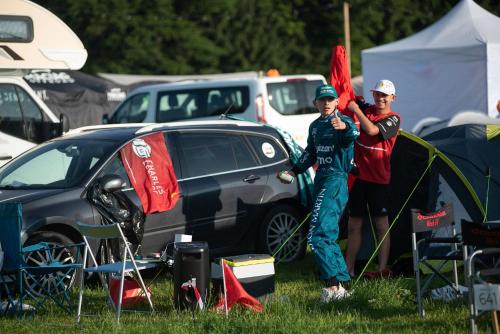two men standing next to a car with a flag at GPtents Camping - Spa in Stavelot