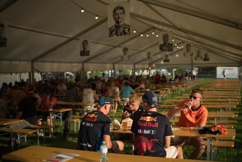 a group of people sitting at tables under a tent at GPtents Camping - Spa in Stavelot