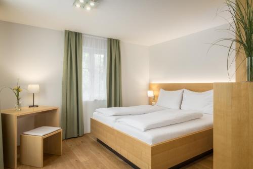 a hotel room with a bed and a window at Hotel OXA - Easy Escape in Hittisau