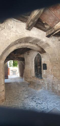 a stone archway in a building with a stone floor at CasaFraBorgo in Sacrofano