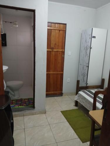 a bathroom with a sink and a toilet and a mirror at Pousada Familiar 31 in Campos dos Goytacazes