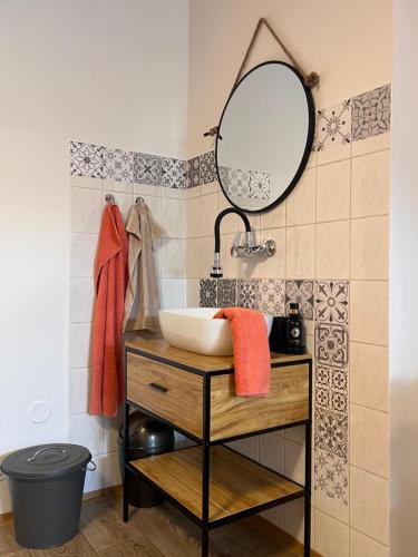 a bathroom with a sink and a mirror at Forton Decco Apartments in Strakonice