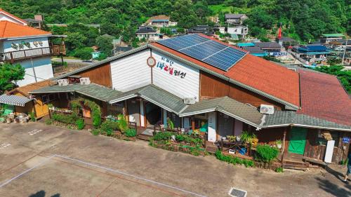 an overhead view of a building with solar panels on it at Jirisan One Night Two Days Pension in Gurye