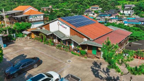 an overhead view of a building with a solar roof at Jirisan One Night Two Days Pension in Gurye