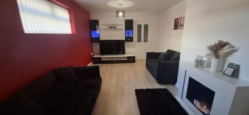 a living room with a couch and a fireplace at Modern 3 bedroom 2 bathroom Free Wifi Central Location in Middlesbrough