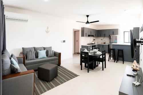 a living room with a couch and a table at Fully Serviced Apartment with 24h Power, Security and Wi-Fi in Sosúa