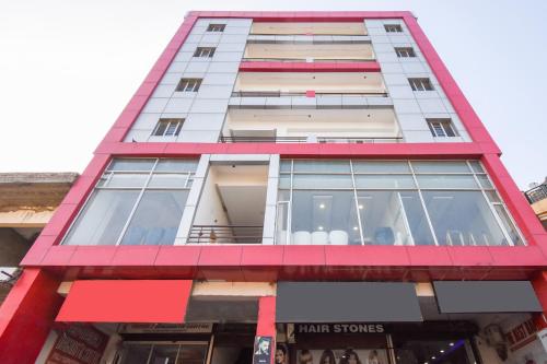 a tall building with red and white trim at Super Hotel o Shivaay Phase 1 Mohali Bus Terminal in Sohāna