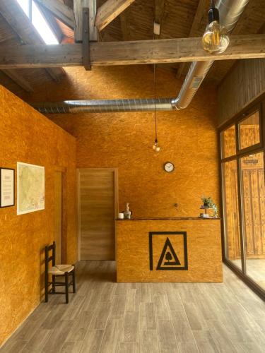 a room with a table with a sign on the wall at El Roble Glamping - Cabaña Alpina - Pet Friendly in Lagunilla