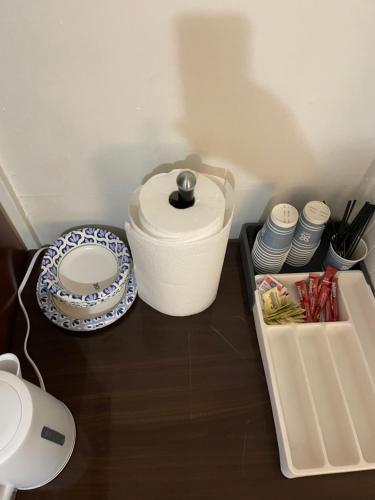a table with a toilet and plates and a container at PRIVATE ROOM ON TAYLOR FULL KITCHEN and BATHROOM shared ARTS RooSEVELT ROW CONVENTION CENTER STADIUMS ASU DOWNTOWN PHOENIX in Phoenix