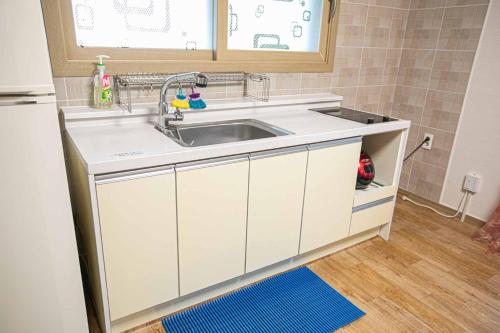 a kitchen with a sink and a counter top at Jirisan One Night Two Days Pension in Gurye