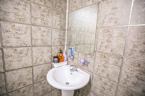 a bathroom with a toilet and a sink at Jirisan One Night Two Days Pension in Gurye