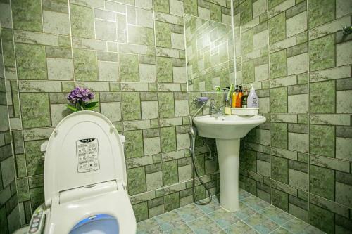 a bathroom with a toilet and a sink at Jirisan One Night Two Days Pension in Gurye