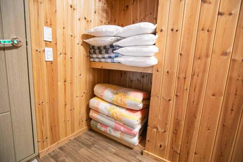 a sauna with a stack of towels in a wooden wall at Jirisan One Night Two Days Pension in Gurye