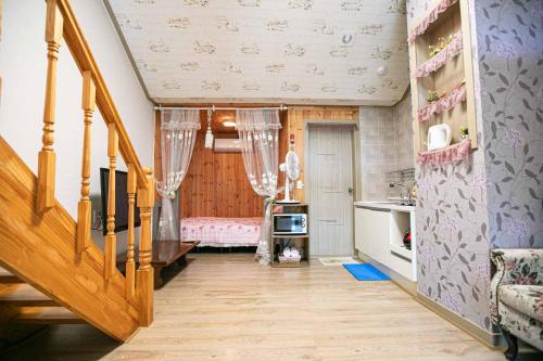 a room with a staircase and a room with a kitchen at Jirisan One Night Two Days Pension in Gurye