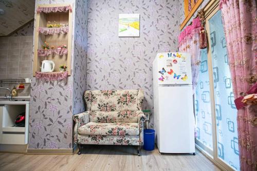 a living room with a chair and a refrigerator at Jirisan One Night Two Days Pension in Gurye
