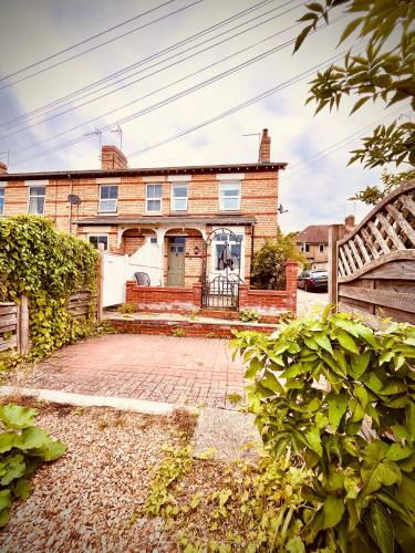 an old brick house with a driveway in front of it at 2 bedroom Hidden Gem in Stamford with parking in Stamford