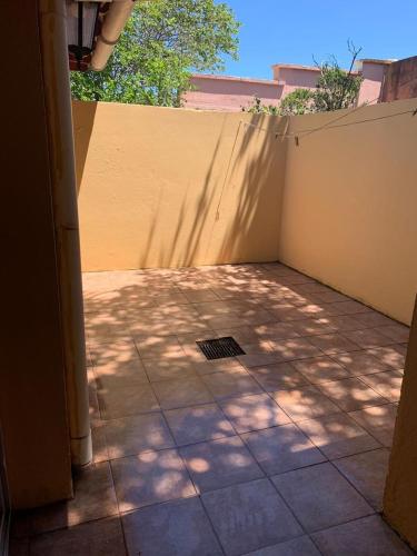 a patio with a wall and a shadow of a tree at chalet en alquiler la 15 in Miramar