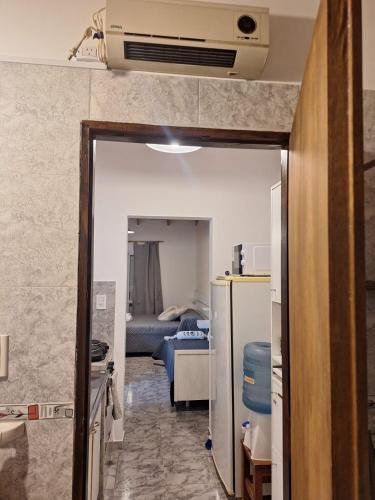 a room with a kitchen and a room with a refrigerator at El Refugio del Calden in Toay