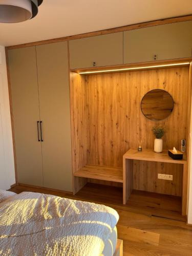 a bedroom with a bed and a wooden wall at STEZKA horský apartmán Dolní Morava in Dolní Morava