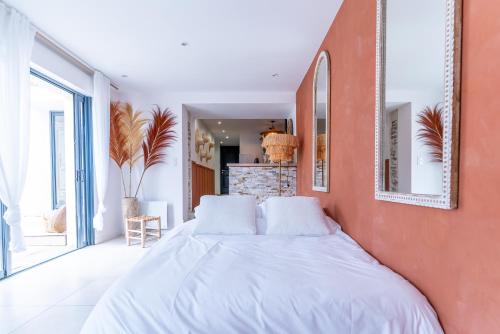 a bedroom with a large bed with white sheets at Maison - Spa - Parking - Jardin - 7p in Vertou