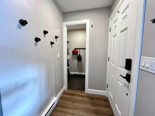 a hallway with a door with hearts on the wall at Cozy Modern 2-Bedroom Condo Between Vail and BC in Avon