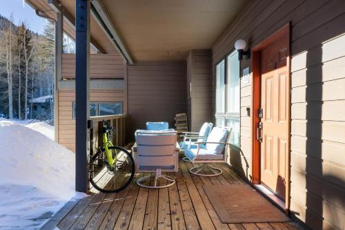 a bike parked on a porch of a house at Cozy Modern 2-Bedroom Condo Between Vail and BC in Avon