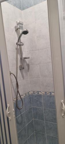 a shower with a shower head in a bathroom at Elìsim House in Caiazzo