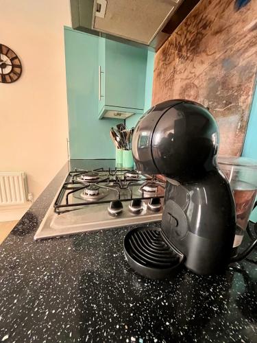 a coffee maker sitting on top of a stove at 2 bedroom Hidden Gem in Stamford with parking in Stamford