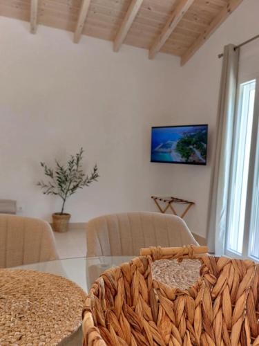 a living room with a glass table and a tv at Villa Eleni Apartment no3 in Agios Gordios