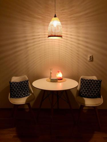 a table and two chairs with a candle on it at Tesla 30 in Kruševac