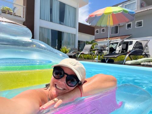 a woman in a pool on a ride in a swimming pool at MarisC&LHouse 1- Quarto casal in Bombinhas