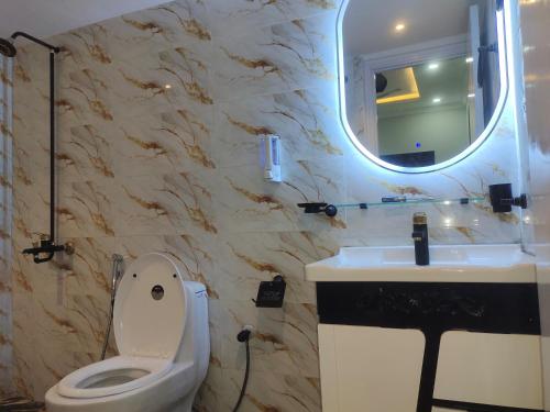 a bathroom with a toilet and a sink and a mirror at Vision 2 Islamabad in Islamabad