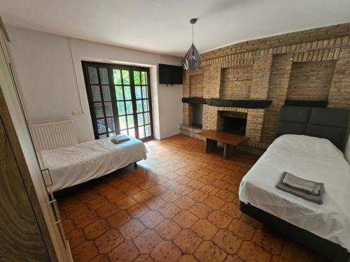 a room with two beds and a fireplace at Monteuerunterkunft FineWood Pension 