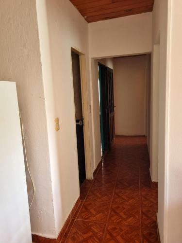 an empty hallway with white walls and a wood floor at complejo lo de Elvira in Miramar