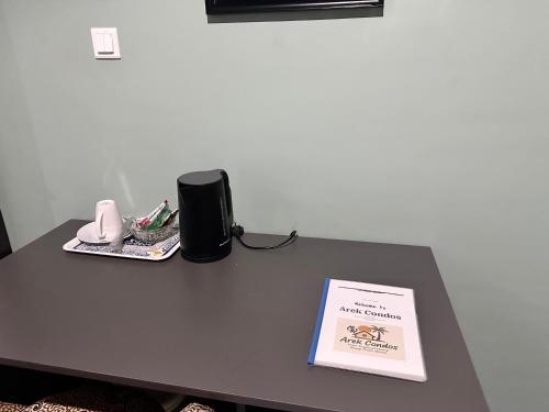 a table with a book on top of it at Arek Condos Accra in Sotuom