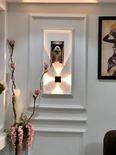 a white door with a light on it at Arek Condos Accra in Sotuom