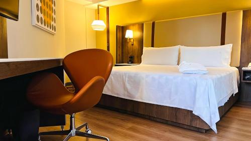 a hotel room with a bed and a chair at Holiday Inn Mexico City-Plaza Universidad by IHG in Mexico City