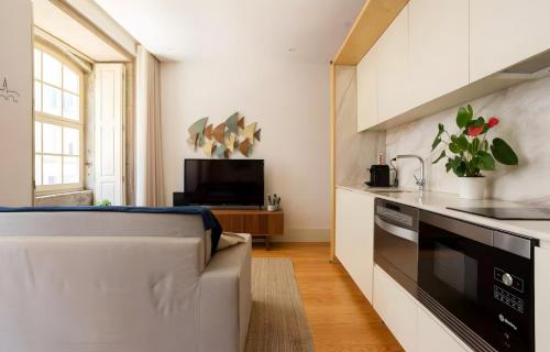 a kitchen with a couch and a stove at Oporto Blue Almada - Deluxe Citycenter Flat in Porto