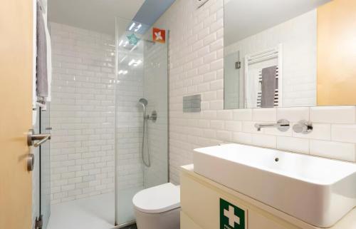 a white bathroom with a sink and a toilet at Oporto Blue Almada - Deluxe Citycenter Flat in Porto