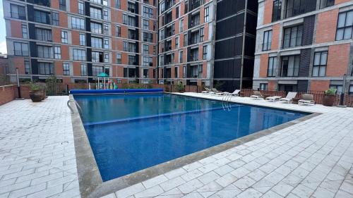 a large swimming pool in the middle of a building at Departamento 2 Recamaras en Torre Anuva con Alberca y Gym in Guadalajara