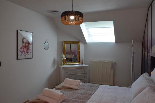 a bedroom with a bed with a mirror and a dresser at Ciné Mirabelle 