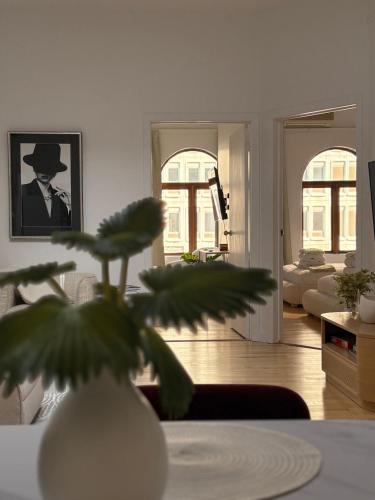 a living room with a vase with a plant in it at La Galerie Privée Luxe & Impeccable Stay in Montréal