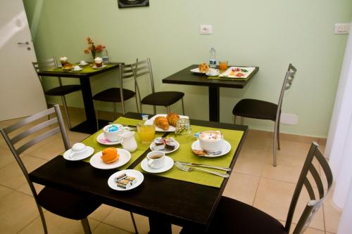 a dining room with a table with food on it at B&B Liberty in Messina