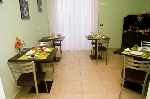 a dining room with tables and chairs with food on them at B&B Liberty in Messina