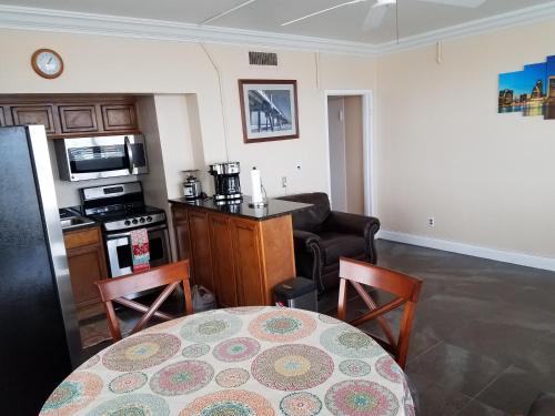 a living room with a table and a kitchen at One Bedroom Downtown in Jacksonville
