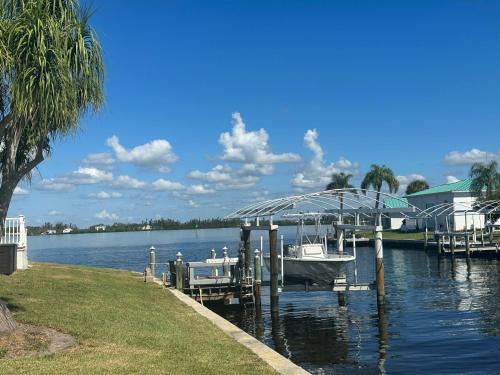 a boat docked at a dock on a lake at Gulf Cove Community in Port Charlotte