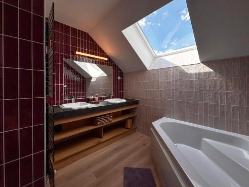 a bathroom with two sinks and a skylight at Ciné Mirabelle 