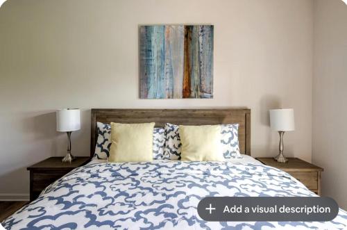 a bedroom with a bed with two lamps and a painting at Desert Princess Serenity Suite in Cathedral City