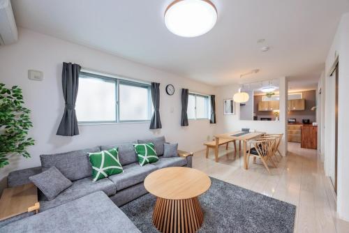 a living room with a couch and a table at House FORMOSA熱田 in Nagoya