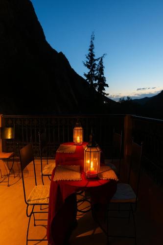 a table on a balcony with candles on it at Auberge La Fibule Du Dades in Aït Idaïr